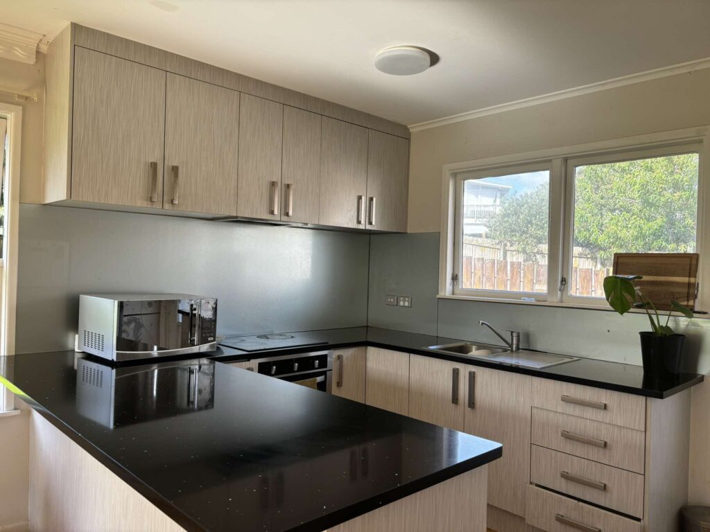 Spotless kitchen with gleaming black countertops