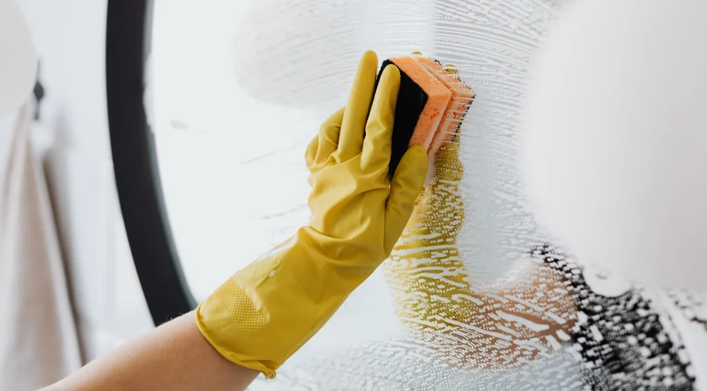Cleaner working on detailed areas of kitchen